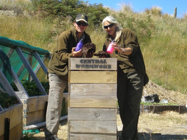 The Blanket Bay ground staff Per Lindstrand and Irene Hartley inspect the worm farm with the Blanket Bay drink bottles at hand